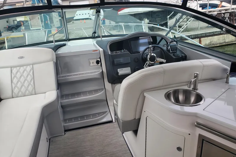Loml Yacht Photos Pics 2020 Regal 33 Express boat interior with helm, seating, and kitchenette.