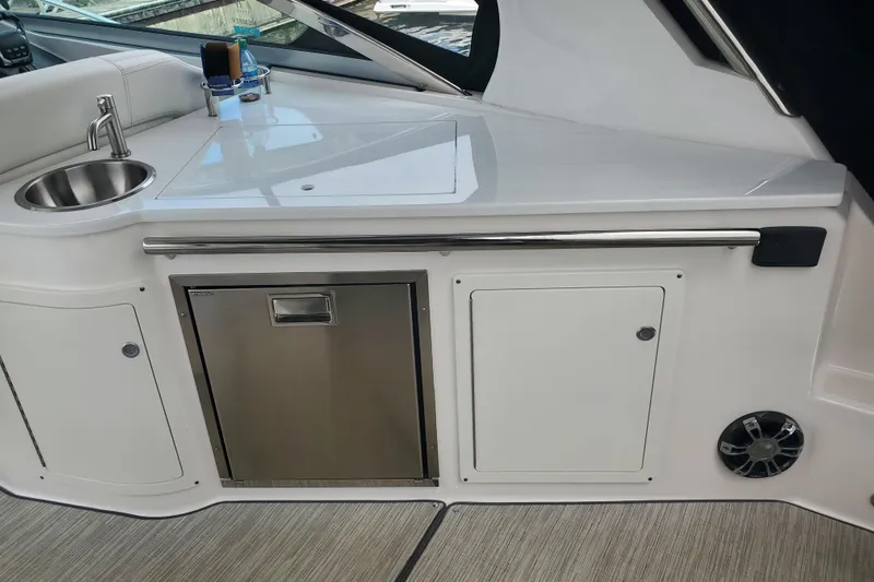 Loml Yacht Photos Pics 2020 Regal 33 Express boat interior with sink, countertop, and storage cabinets.