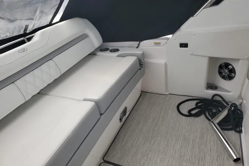 Loml Yacht Photos Pics 2020 Regal 33 Express boat interior with cushioned seating and cup holders.