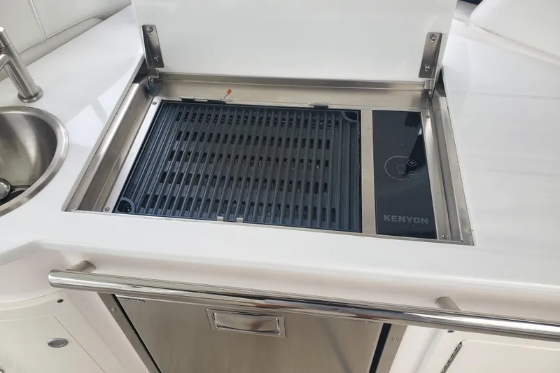 Loml Yacht Photos Pics Built-in Kenyon grill on 2020 Regal 33 Express yacht, featuring stainless steel finish.