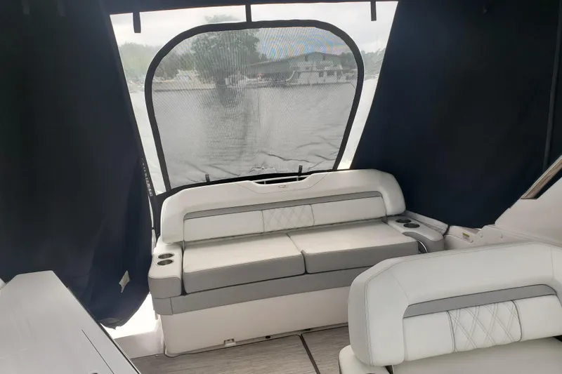 Loml Yacht Photos Pics 2020 Regal 33 Express boat interior with cushioned seating and lake view.