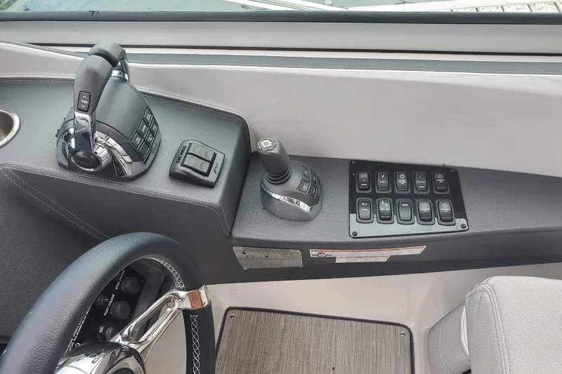 Loml Yacht Photos Pics Control panel of 2020 Regal 33 Express boat with steering wheel and switches.