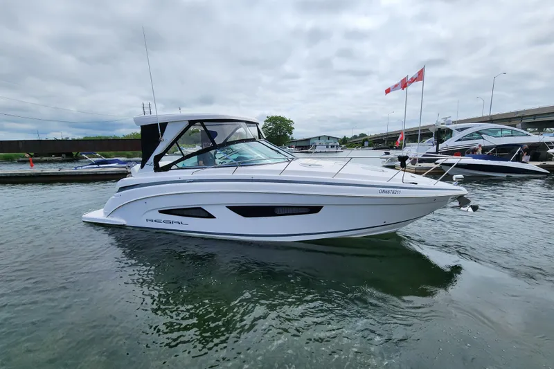 Loml Yacht Photos Pics 2020 Regal 33 Express boat docked in marina, overcast sky, Canadian flags visible.