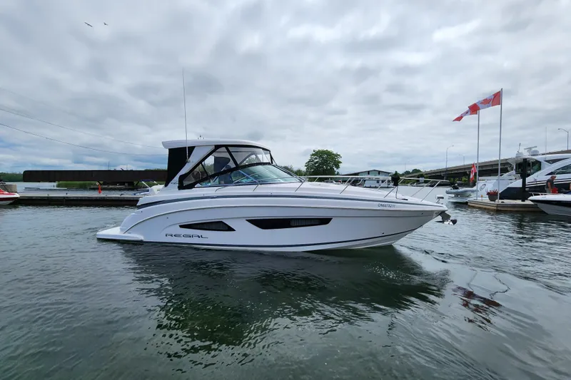 Loml Yacht Photos Pics 2020 Regal 33 Express boat docked in a marina with Canadian flags.