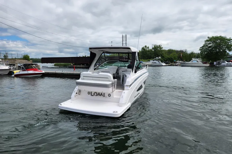 Loml Yacht Photos Pics 2020 Regal 33 Express boat docked in a marina with cloudy skies.