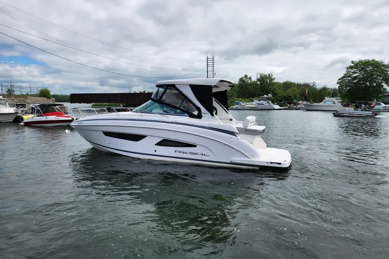 Loml Yacht Photos Pics 2020 Regal 33 Express boat docked in a marina, surrounded by other boats.