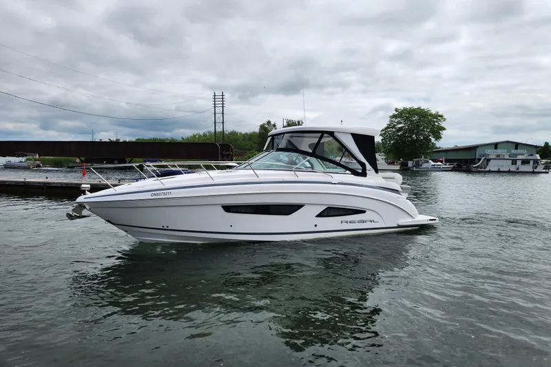 Loml Yacht Photos Pics 2020 Regal 33 Express boat docked at marina under cloudy sky.