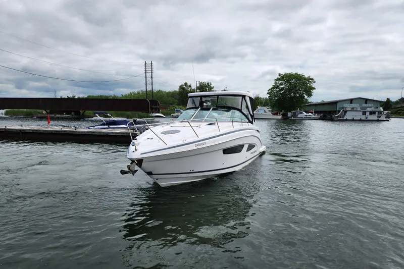 Loml Yacht Photos Pics 2020 Regal 33 Express boat docked at marina under cloudy sky.