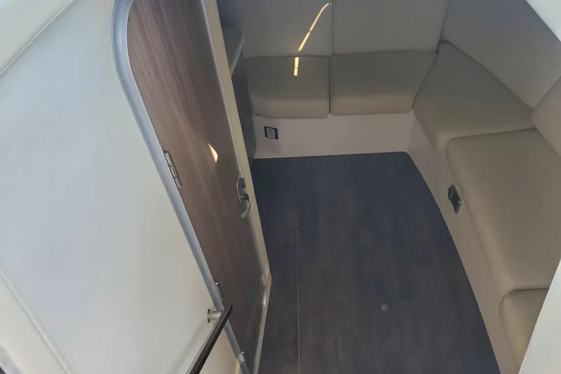 Loml Yacht Photos Pics 2020 Regal 33 Express cabin interior with beige seating and wooden flooring.