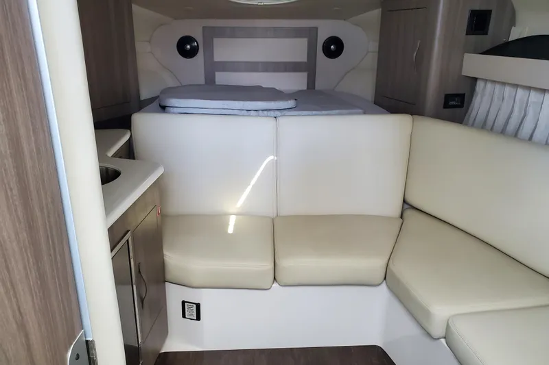 Loml Yacht Photos Pics 2020 Regal 33 Express boat interior with beige seating and compact kitchenette.