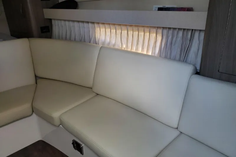 Loml Yacht Photos Pics 2020 Regal 33 Express interior with cream leather seating and elegant curtains.