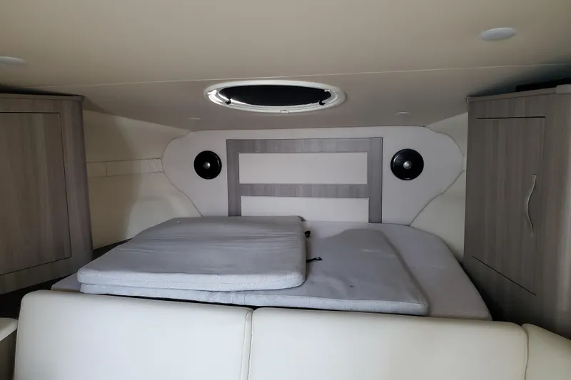 Loml Yacht Photos Pics 2020 Regal 33 Express cabin interior with bed and storage cabinets.
