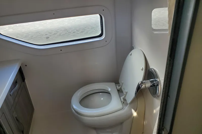 Loml Yacht Photos Pics 2020 Regal 33 Express boat bathroom with toilet and window.
