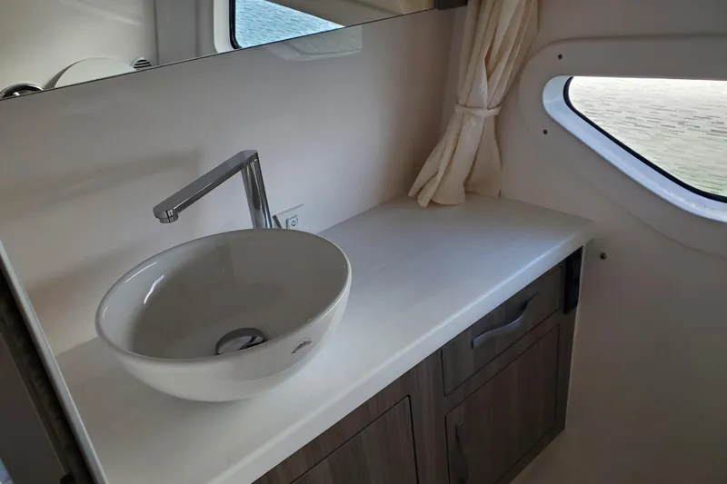 Loml Yacht Photos Pics Modern bathroom sink in 2020 Regal 33 Express yacht, featuring sleek design and window view.