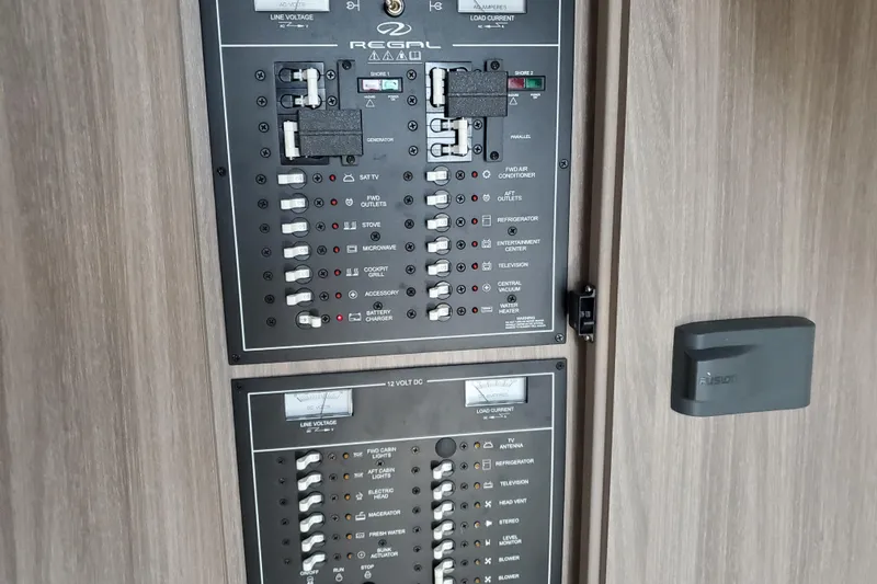 Loml Yacht Photos Pics Electrical control panel on a 2020 Regal 33 Express boat, featuring various switches and indicators.