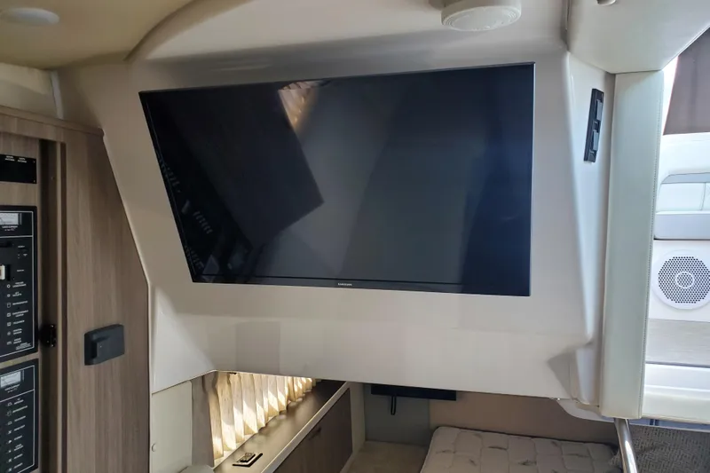 Loml Yacht Photos Pics Interior of 2020 Regal 33 Express yacht with mounted flat-screen TV.