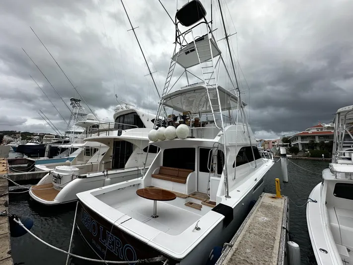  Yacht Photos Pics 2003 Viking 52 yacht docked at marina under cloudy skies.