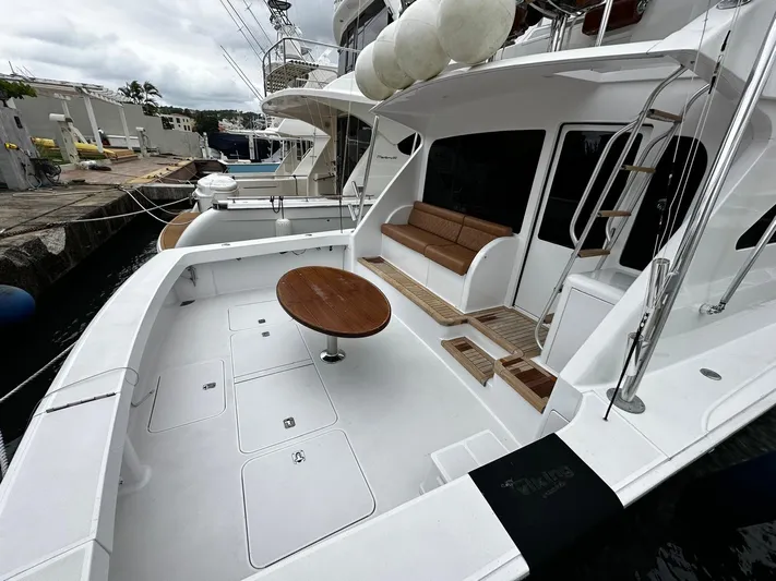  Yacht Photos Pics 2003 Viking 52 yacht with spacious deck, seating, and round table, docked at marina.