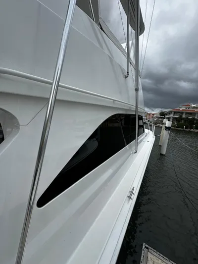  Yacht Photos Pics 2003 Viking 52 yacht docked, sleek white exterior, overcast sky.