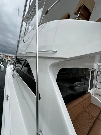  Yacht Photos Pics 2003 Viking 52 yacht, sleek white exterior, docked with overcast sky.