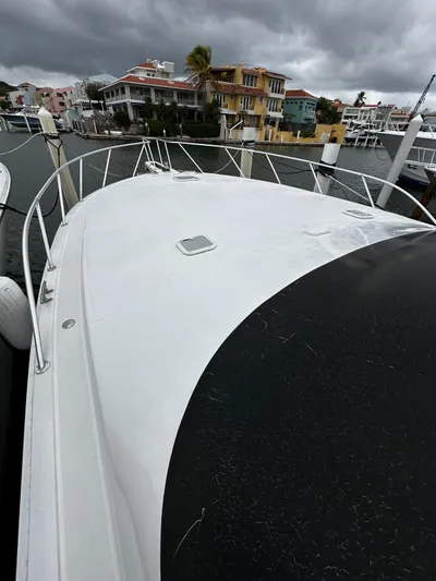  Yacht Photos Pics 2003 Viking 52 yacht docked, showcasing sleek deck design under cloudy skies.