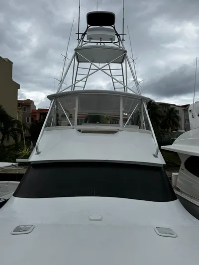  Yacht Photos Pics 2003 Viking 52 yacht with tower against cloudy sky in marina.