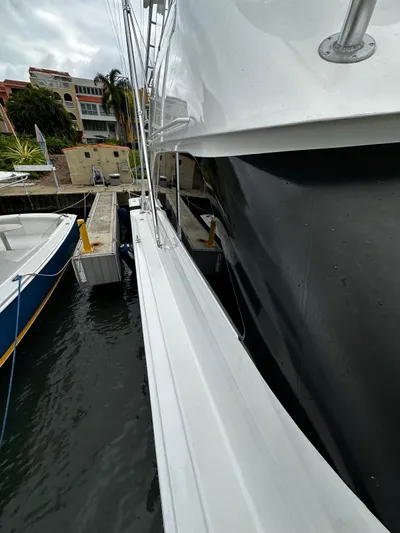  Yacht Photos Pics Side view of a 2003 Viking 52 yacht docked at a marina.