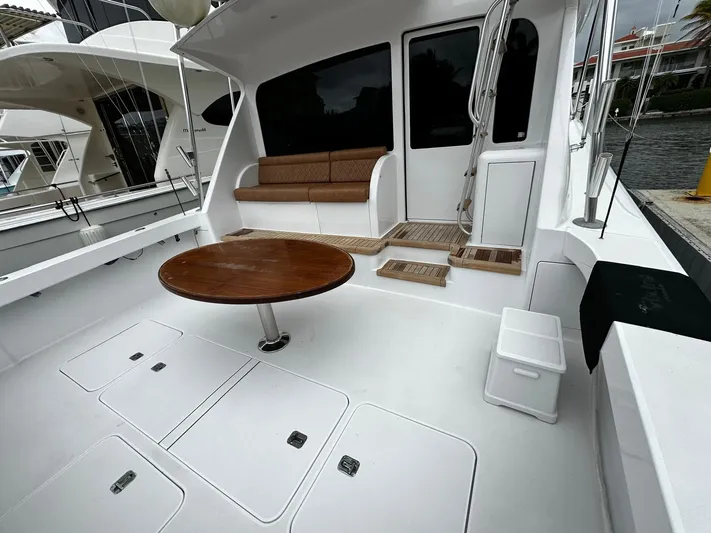  Yacht Photos Pics 2003 Viking 52 yacht cockpit with seating, table, and storage compartments.