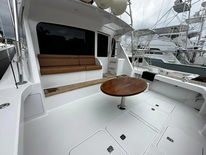  Yacht Photos Pics 2003 Viking 52 yacht deck with seating and table, docked at marina.