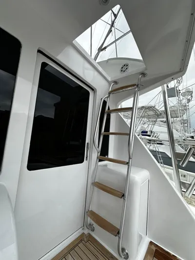  Yacht Photos Pics 2003 Viking 52 yacht with ladder and sleek white exterior.