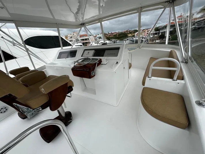 Yacht Photos Pics Luxurious 2003 Viking 52 yacht helm with plush seating and modern controls.