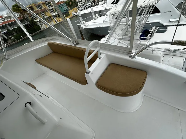  Yacht Photos Pics 2003 Viking 52 yacht deck with cushioned seating and marina view.