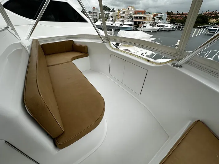  Yacht Photos Pics 2003 Viking 52 yacht with tan seating, docked at marina with multiple boats.