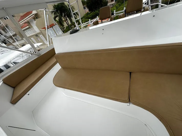  Yacht Photos Pics Interior seating area of a 2003 Viking 52 yacht with beige cushions.