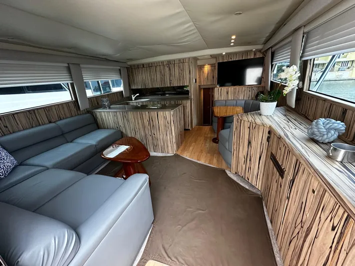  Yacht Photos Pics Luxurious interior of a 2003 Viking 52 yacht with modern furnishings and ample natural light.