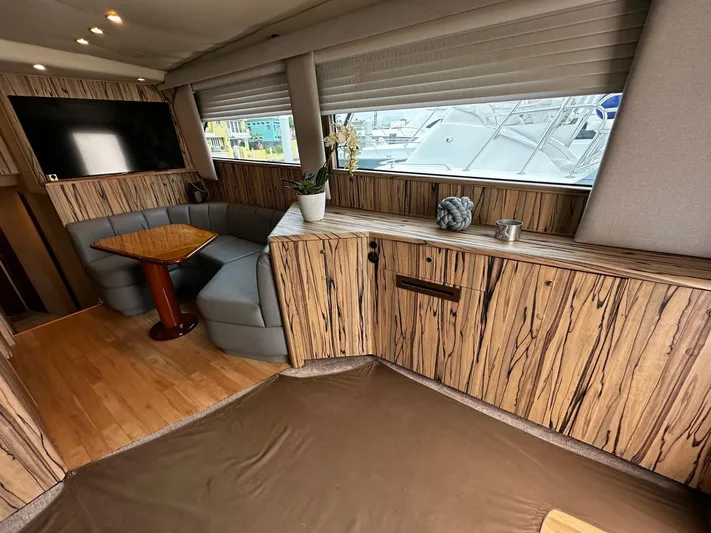  Yacht Photos Pics Luxurious 2003 Viking 52 yacht interior with wood paneling, cozy seating, and large windows.