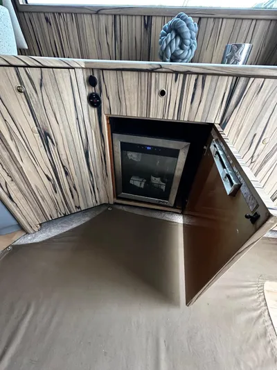  Yacht Photos Pics 2003 Viking 52 interior with open cabinet and mini fridge.