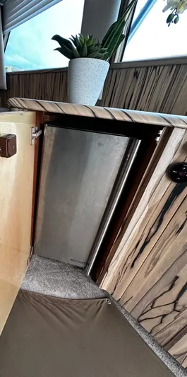  Yacht Photos Pics Compact kitchen area in a 2003 Viking 52 yacht with stainless steel fridge.