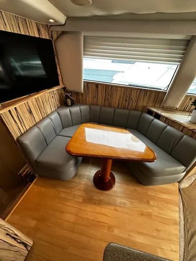  Yacht Photos Pics 2003 Viking 52 yacht interior with a cozy dining area and wooden table.