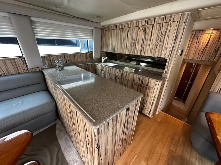  Yacht Photos Pics Luxurious interior of a 2003 Viking 52 yacht with modern kitchen and seating area.