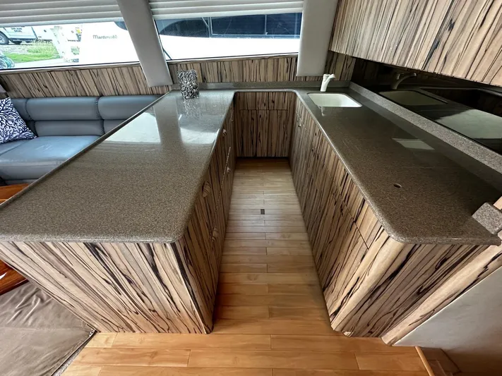  Yacht Photos Pics Luxurious interior of 2003 Viking 52 yacht with modern kitchen and seating area.