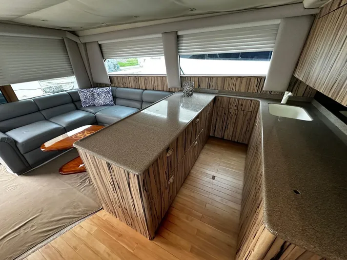  Yacht Photos Pics Luxurious interior of a 2003 Viking 52 yacht with modern kitchen and seating area.