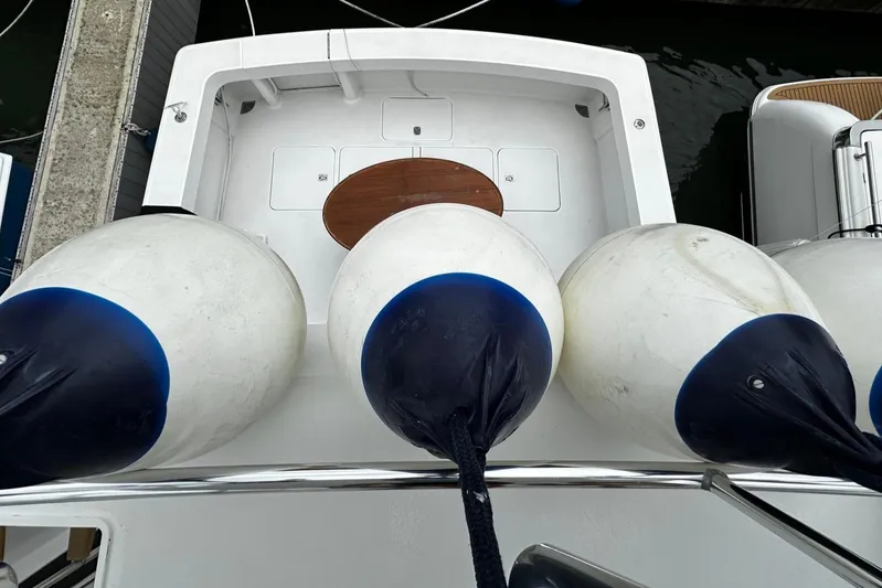  Yacht Photos Pics Four large white fenders on a 2003 Viking 52 yacht docked at a marina.