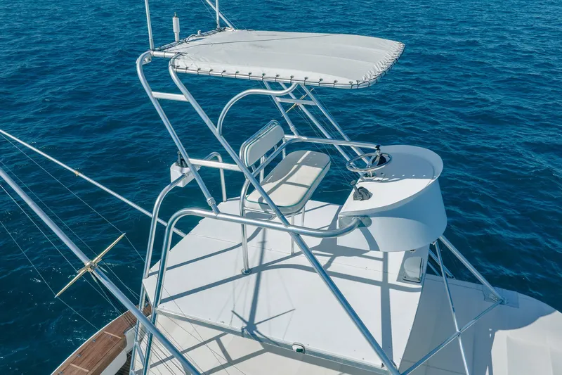 It Is Well Yacht Photos Pics 1997 Strike 42 Express boat with elevated helm station on open sea.