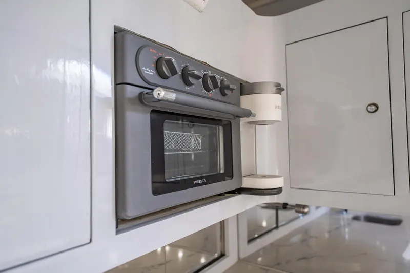 It Is Well Yacht Photos Pics Built-in oven and coffee maker in a 1997 Strike 42 Express yacht kitchen.