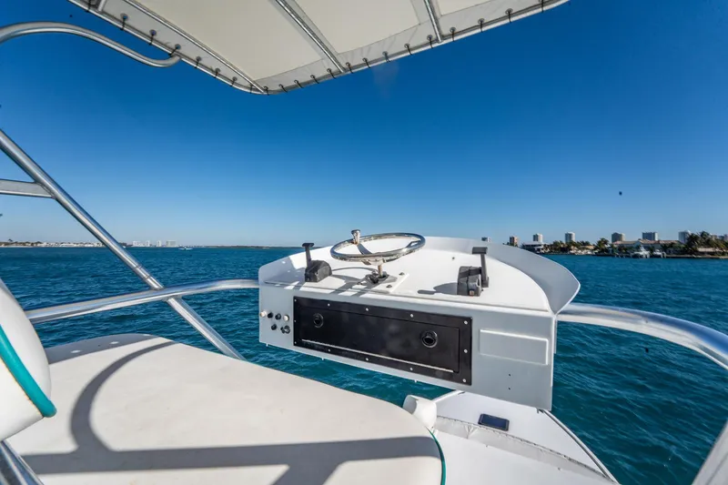 It Is Well Yacht Photos Pics Helm of 1997 Strike 42 Express boat with ocean view and clear blue sky.