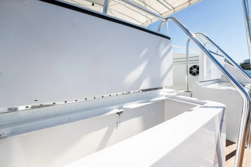 It Is Well Yacht Photos Pics 1997 Strike 42 Express boat interior with open storage compartments and stainless steel railings.