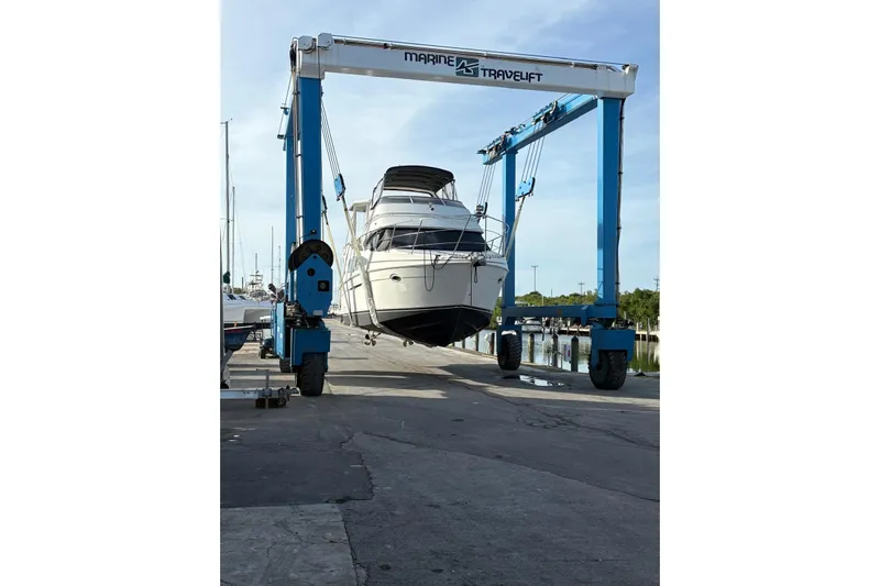 Reel Dezire Yacht Photos Pics 2005 Carver 41 Cockpit Motor Yacht lifted by Marine Travelift at dock.