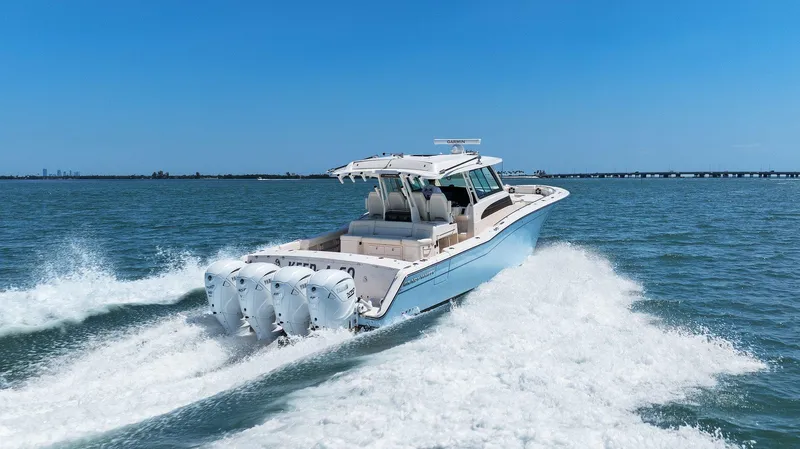  Yacht Photos Pics 2023 Grady-White Canyon 456 boat cruising on open water, showcasing powerful engines.