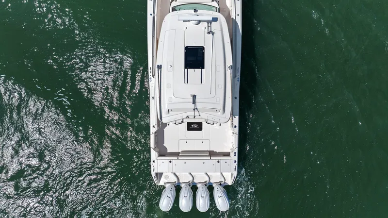  Yacht Photos Pics 2023 Grady-White Canyon 456 boat, aerial view, cruising on green water.